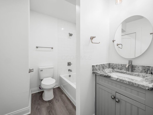 full bathroom featuring vanity, tiled shower / bath, wood-type flooring, and toilet