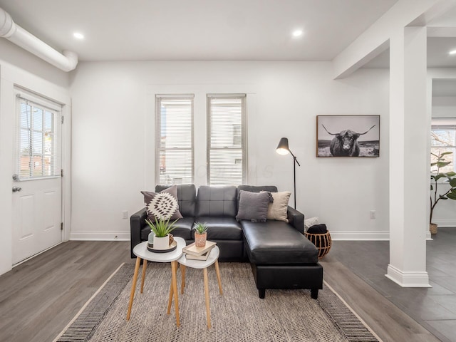 living room featuring a wealth of natural light and dark hardwood / wood-style floors