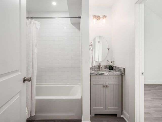 bathroom with vanity, wood-type flooring, and shower / bathtub combination with curtain