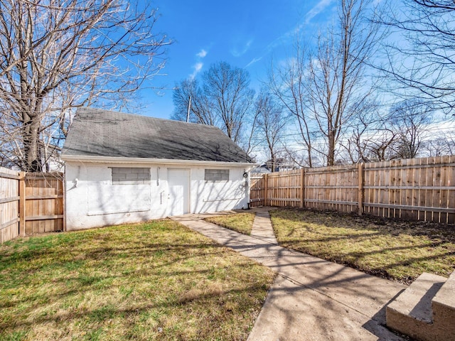 view of yard featuring a garage and an outbuilding