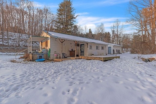 view of snow covered rear of property