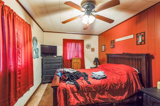 carpeted bedroom featuring ceiling fan and ornamental molding