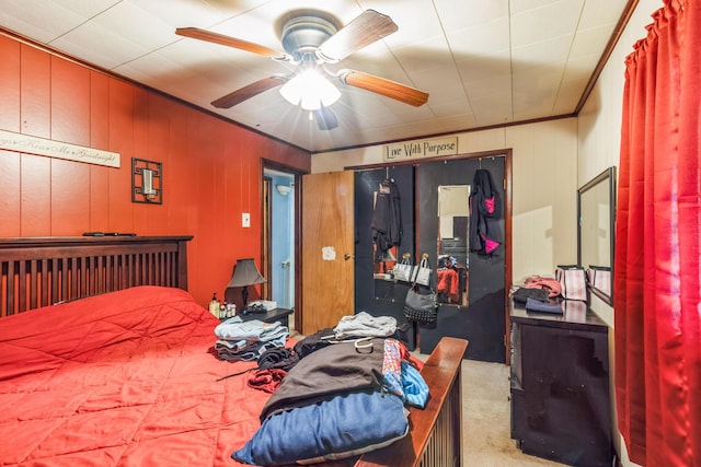 carpeted bedroom featuring ceiling fan and ornamental molding