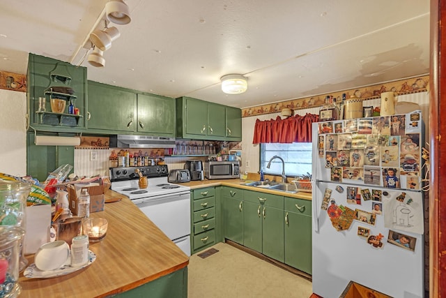 kitchen featuring white appliances, sink, and green cabinetry