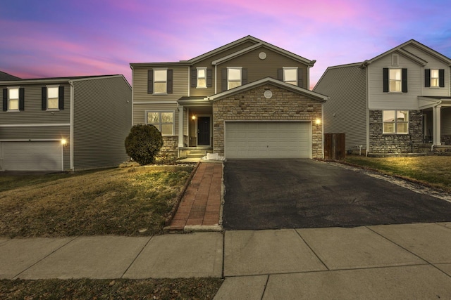 front of property with a garage and a yard