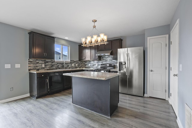 kitchen featuring a kitchen island, black dishwasher, range, exhaust hood, and stainless steel refrigerator with ice dispenser