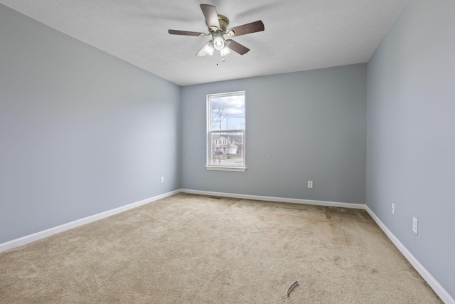 unfurnished room with ceiling fan, carpet, and a textured ceiling