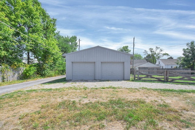 detached garage featuring fence