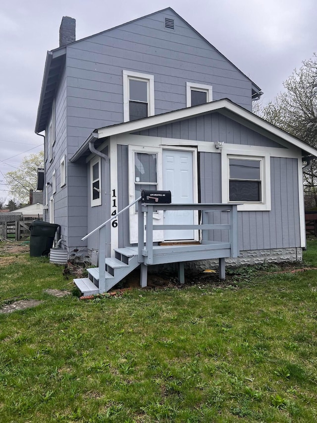 1146 Brentnell Ave, Columbus, OH 43219 - back of property featuring a chimney, a lawn, and a deck