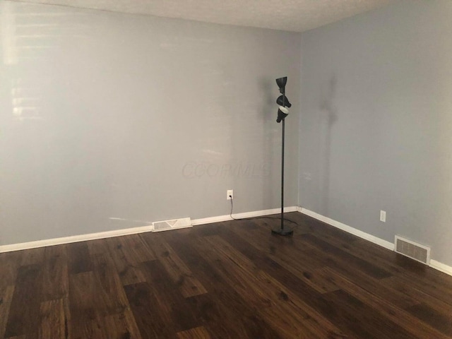 unfurnished room with hardwood / wood-style flooring