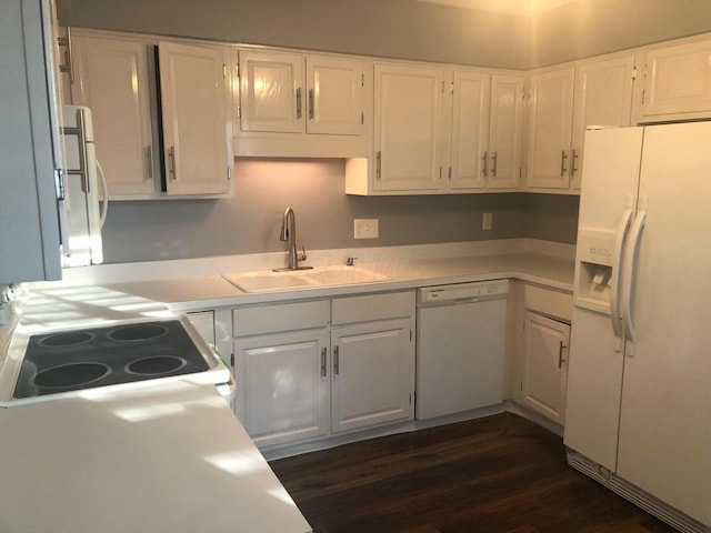 kitchen with dark hardwood / wood-style floors, white cabinetry, sink, and white appliances