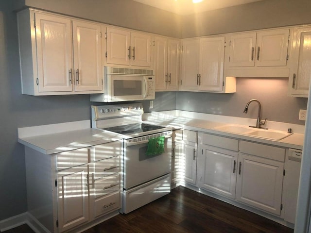 kitchen with white cabinetry, white appliances, dark hardwood / wood-style floors, and sink