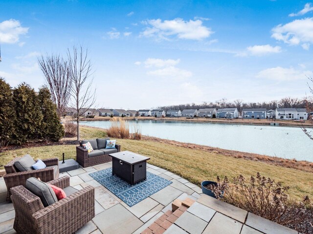 view of patio with outdoor lounge area, a residential view, and a water view