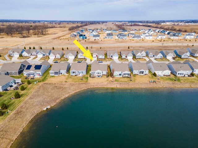 drone / aerial view featuring a residential view and a water view