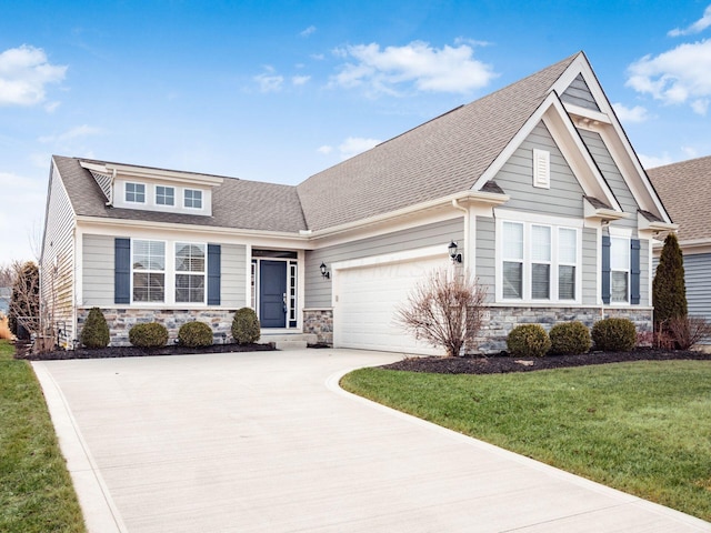 craftsman house with a garage, a shingled roof, stone siding, driveway, and a front yard