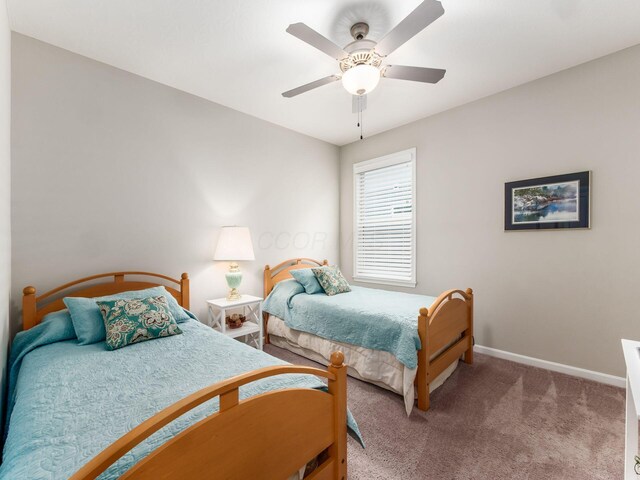 carpeted bedroom with baseboards and a ceiling fan