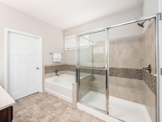 full bathroom featuring a garden tub and a shower stall