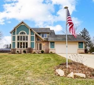 view of front of house featuring a garage and a front yard