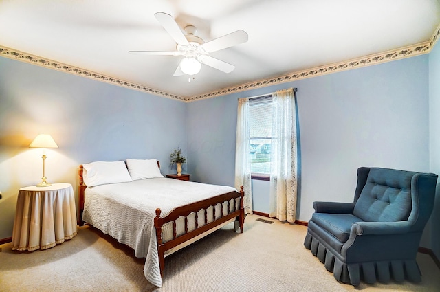 carpeted bedroom with visible vents, ceiling fan, and baseboards