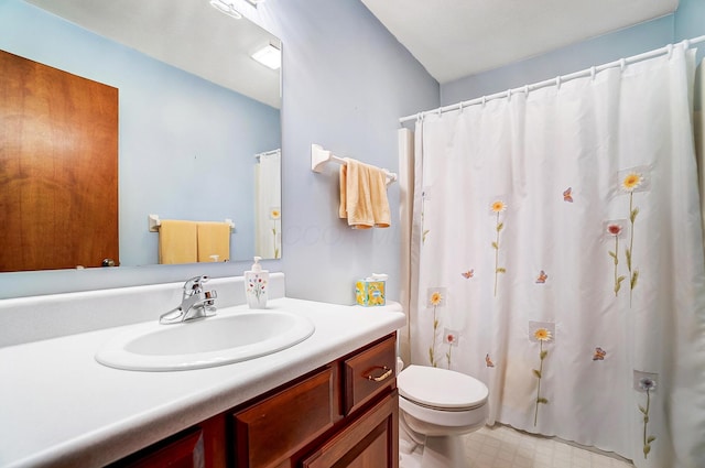 bathroom featuring toilet, tile patterned floors, and vanity