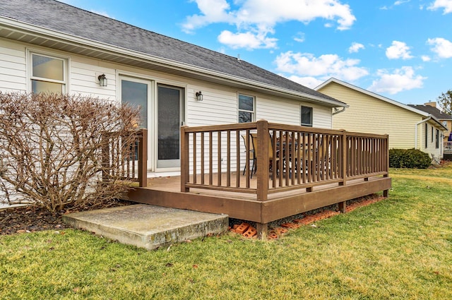 wooden terrace featuring a lawn