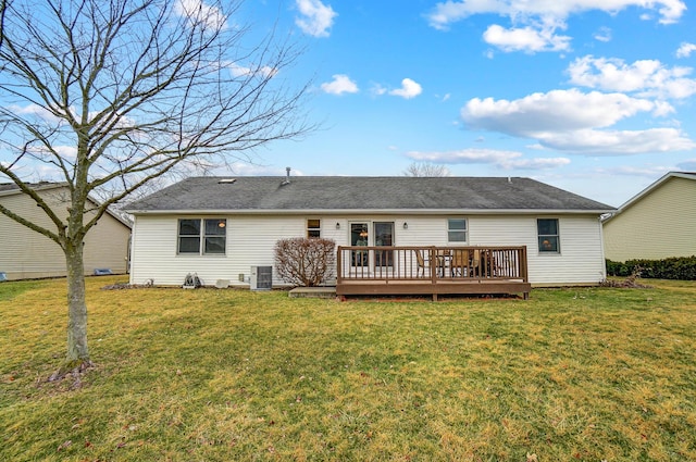 rear view of property with central air condition unit, a deck, and a yard