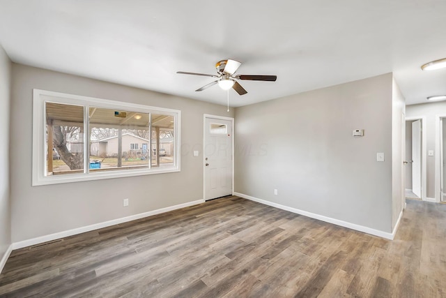 spare room with hardwood / wood-style floors and ceiling fan