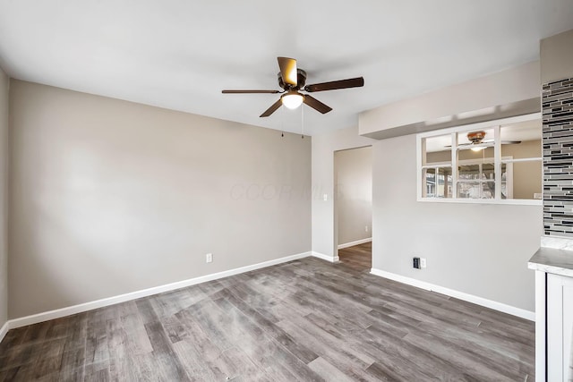 spare room with ceiling fan and wood-type flooring