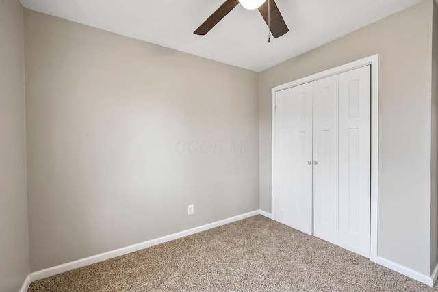 unfurnished bedroom featuring ceiling fan, carpet floors, and a closet