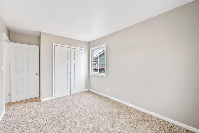 unfurnished bedroom featuring carpet floors and a closet