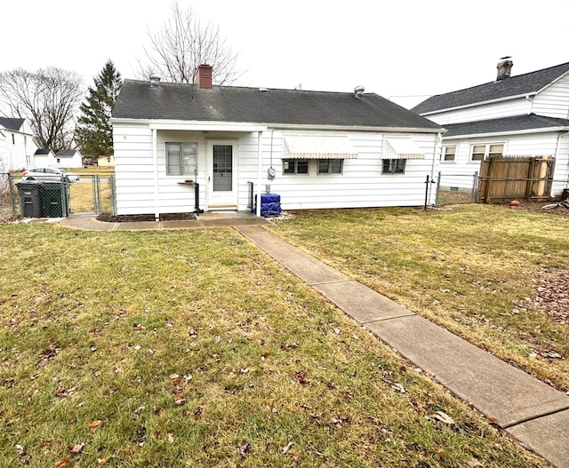 rear view of house with a lawn