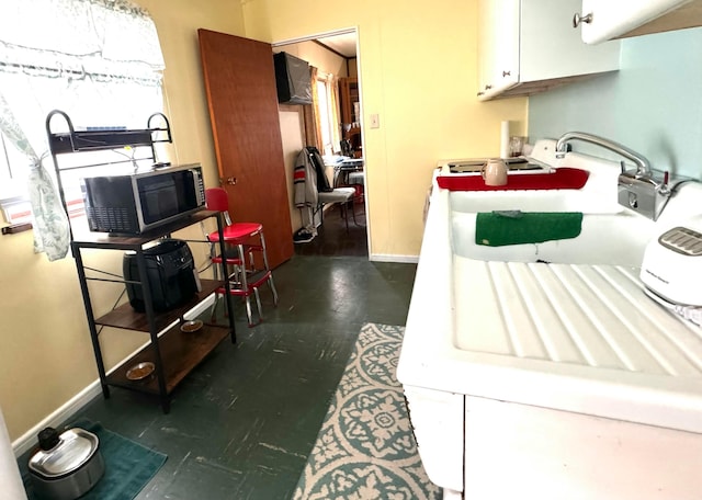 kitchen with dark hardwood / wood-style flooring and white cabinets