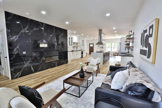 living room with a fireplace and light wood-type flooring