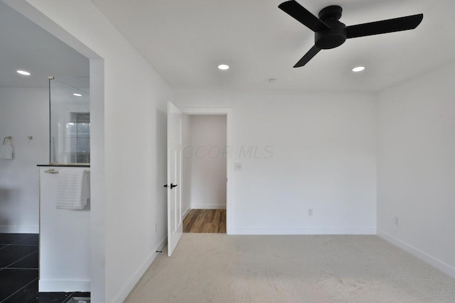 carpeted empty room with ceiling fan