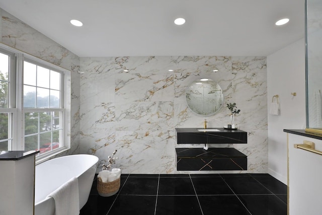 bathroom with vanity, a tub to relax in, and tile patterned floors