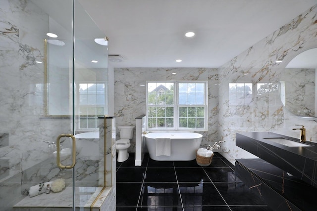 full bathroom featuring independent shower and bath, sink, tile walls, tile patterned flooring, and toilet