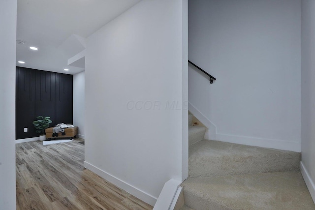 staircase with wood-type flooring