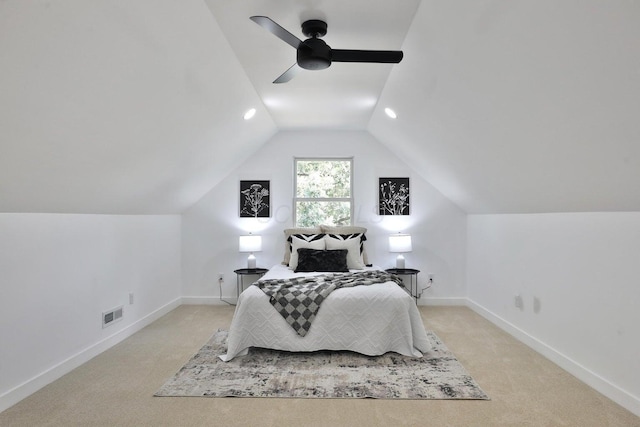 carpeted bedroom with vaulted ceiling and ceiling fan