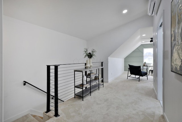 interior space featuring lofted ceiling, light carpet, and a wall unit AC