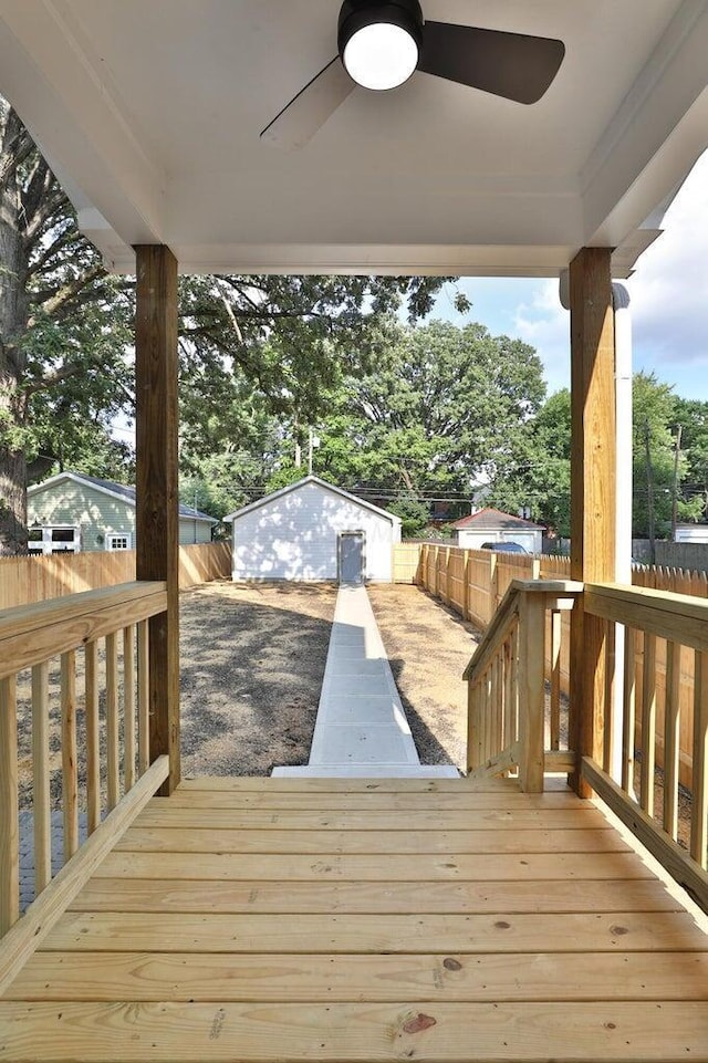 wooden deck with a garage and an outdoor structure