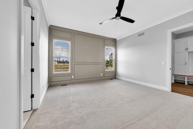 unfurnished bedroom with ceiling fan, light colored carpet, and ornamental molding