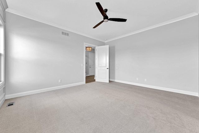 carpeted empty room with ornamental molding and ceiling fan