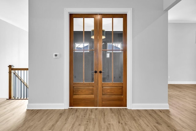 interior space with light hardwood / wood-style floors and french doors