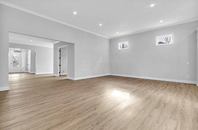 interior space with ornamental molding, plenty of natural light, and light wood-type flooring