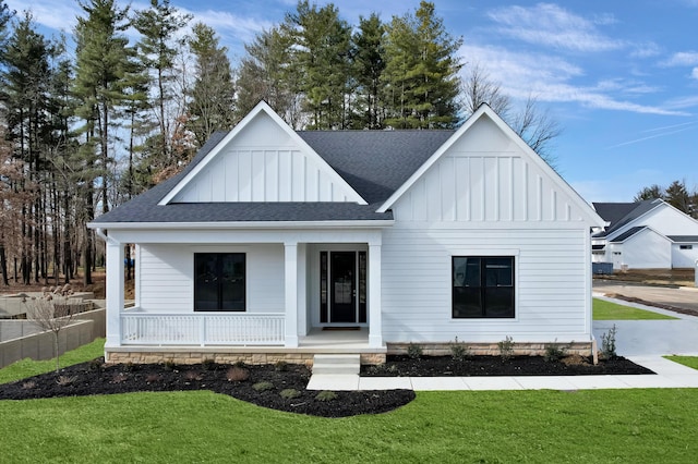 modern farmhouse with covered porch and a front yard