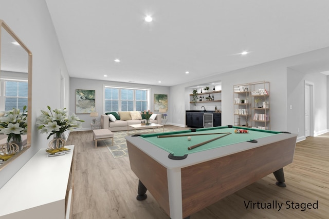 playroom with billiards, light hardwood / wood-style floors, and bar area