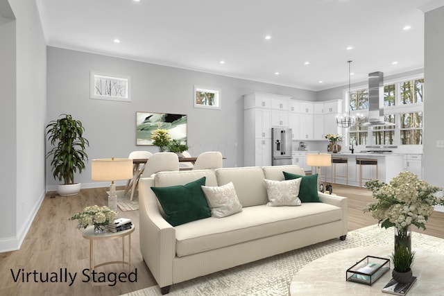 living room with crown molding, sink, an inviting chandelier, and light wood-type flooring