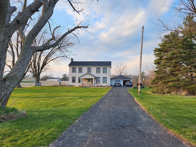 colonial-style house with a lawn