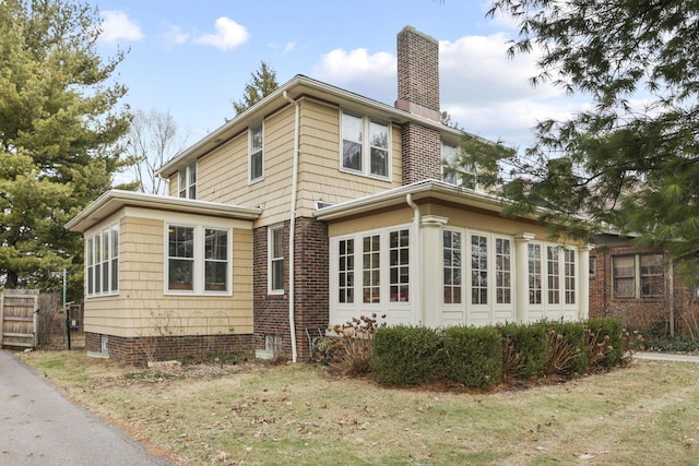 view of side of home with a lawn