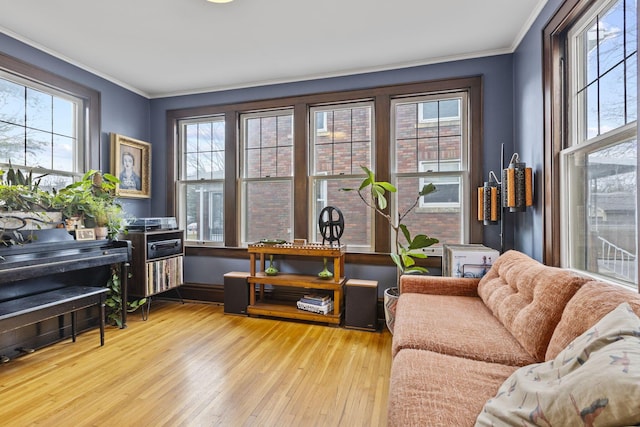 sitting room with ornamental molding and plenty of natural light